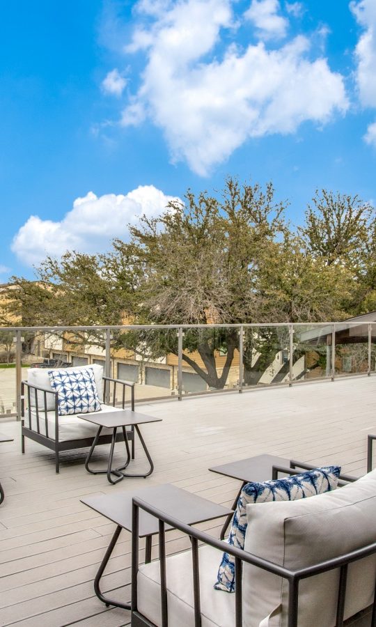 the deck has a large patio with furniture and a view of the city at The Live Oak at  Branch